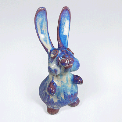 Photo of rabbit-standing-blue-purple sculpture.
